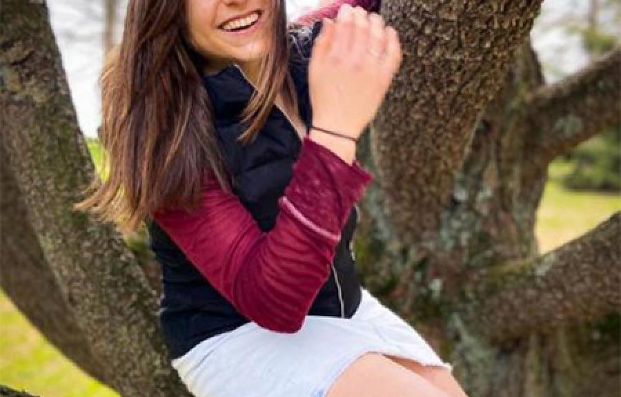 Undergraduate student, Raisa Kochmaruk shown sitting in a tree