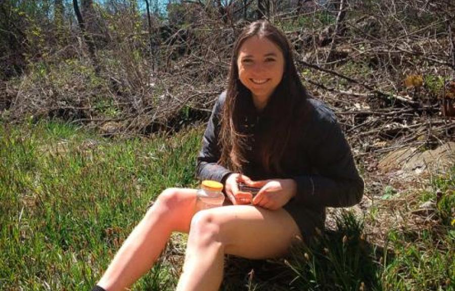 Undergraduate student, Raisa Kochmaruk shown sitting down on a hillside