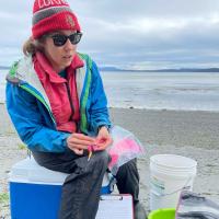 Olivia Graham, eelgrass researcher in the field with her collecting supplies