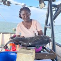 Angela taking measurements of fish weight at Winam Gulf, Lake Victoria. Photocredit_Winnie Owoko, KMFRI Kenya