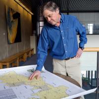 Bob Howarth shown looking at a map in Corson Hall.