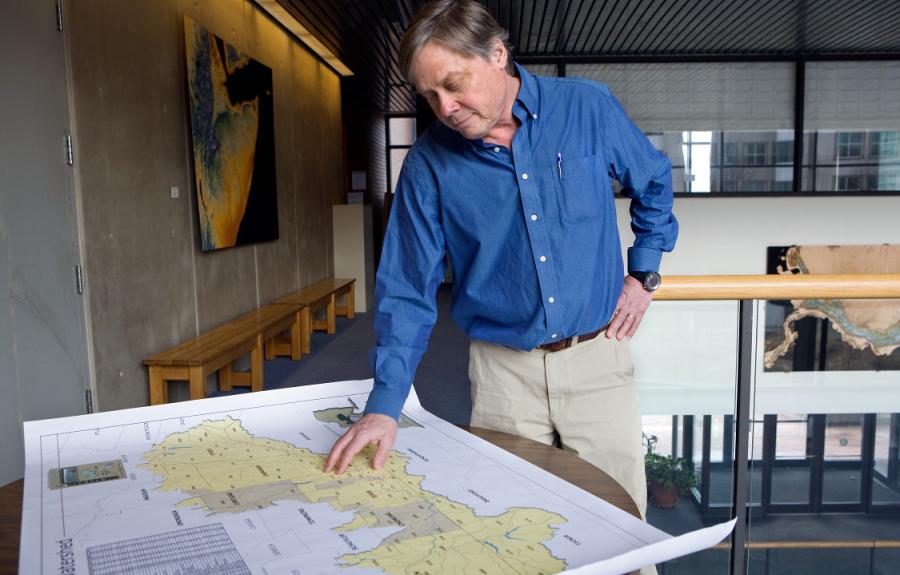 Bob Howarth shown looking at a map in Corson Hall.