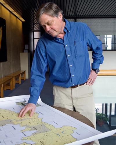 Bob Howarth views a map in Corson Hall on the Cornell campus.