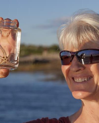 Drew Harvell with brittlestar by David O. Brown