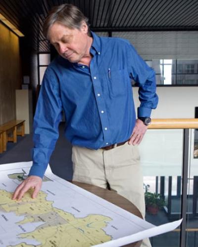 EEB professor Rob Howarth examines map